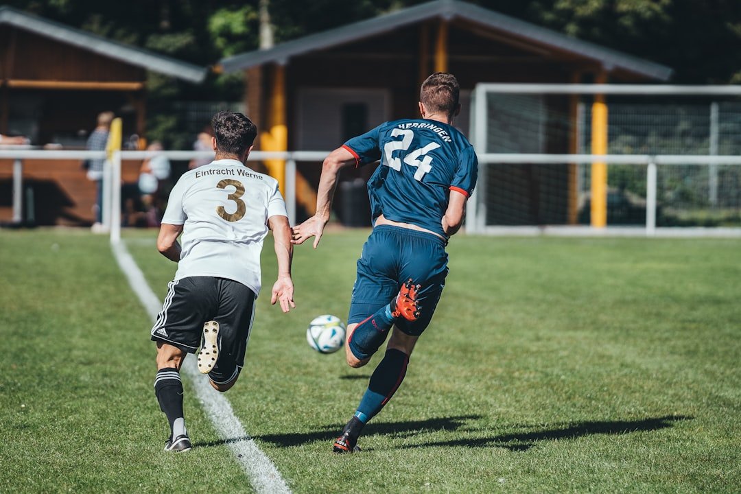 2-men-playing-soccer-on-green-grass-field-during-daytime-wdqz3rbcogq