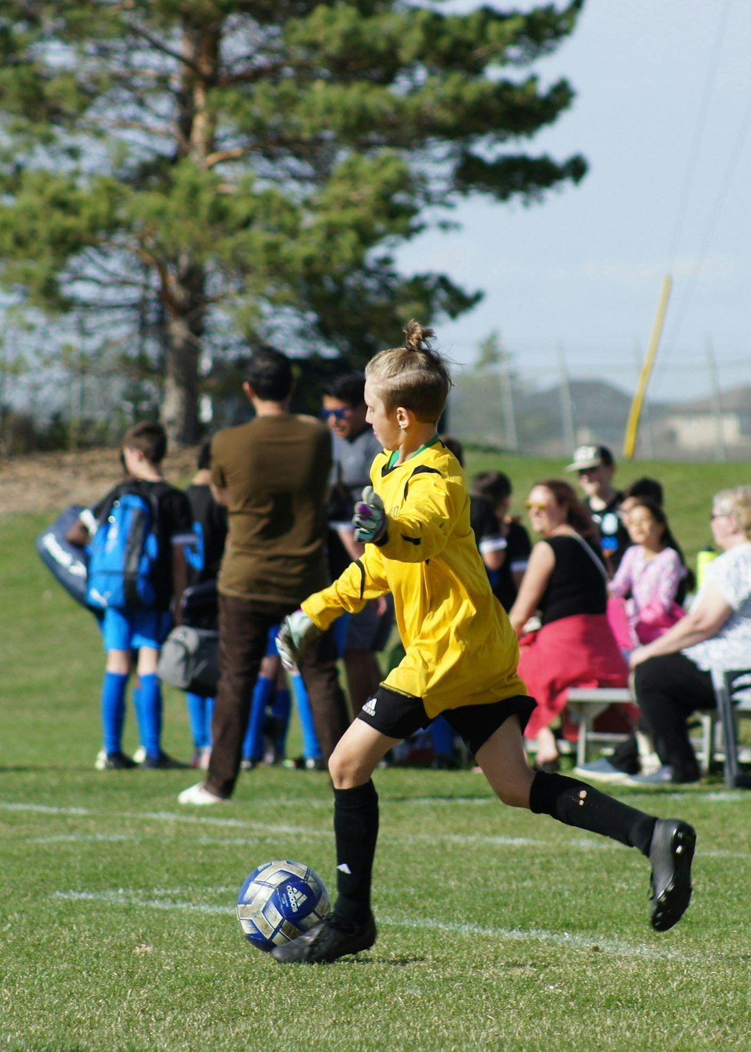 a-young-girl-kicking-a-soccer-ball-on-a-field-xbjp29gike